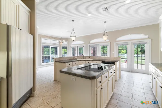 a kitchen with stainless steel appliances granite countertop a sink and a refrigerator