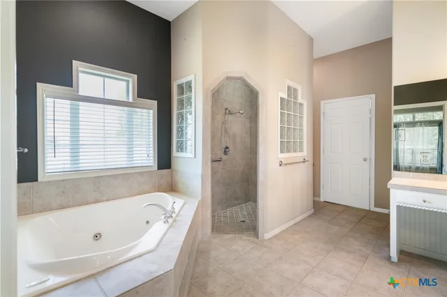 a bathroom with a bathtub and a shower