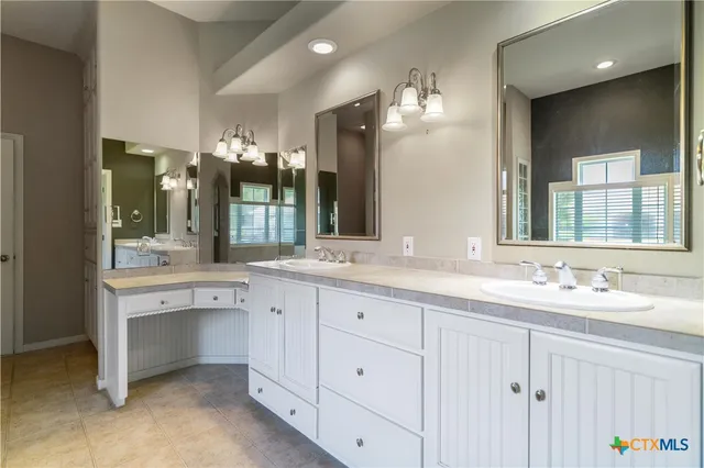 a bathroom with a double vanity sink and a mirror