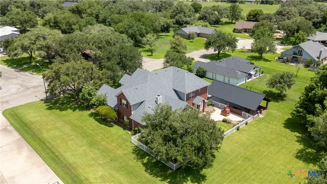 an aerial view of a house with a yard