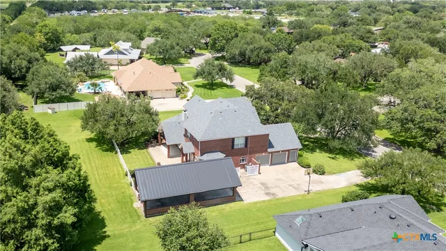 an aerial view of a house with a yard basket ball court and outdoor seating