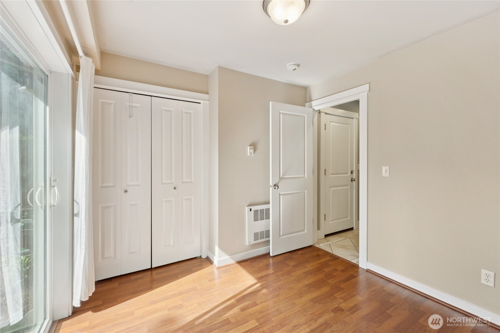 9503 Ashworth Avenue North, Unit B Seattle, WA 98103 - Photo 4 of 26 a view of an empty room and wooden floor