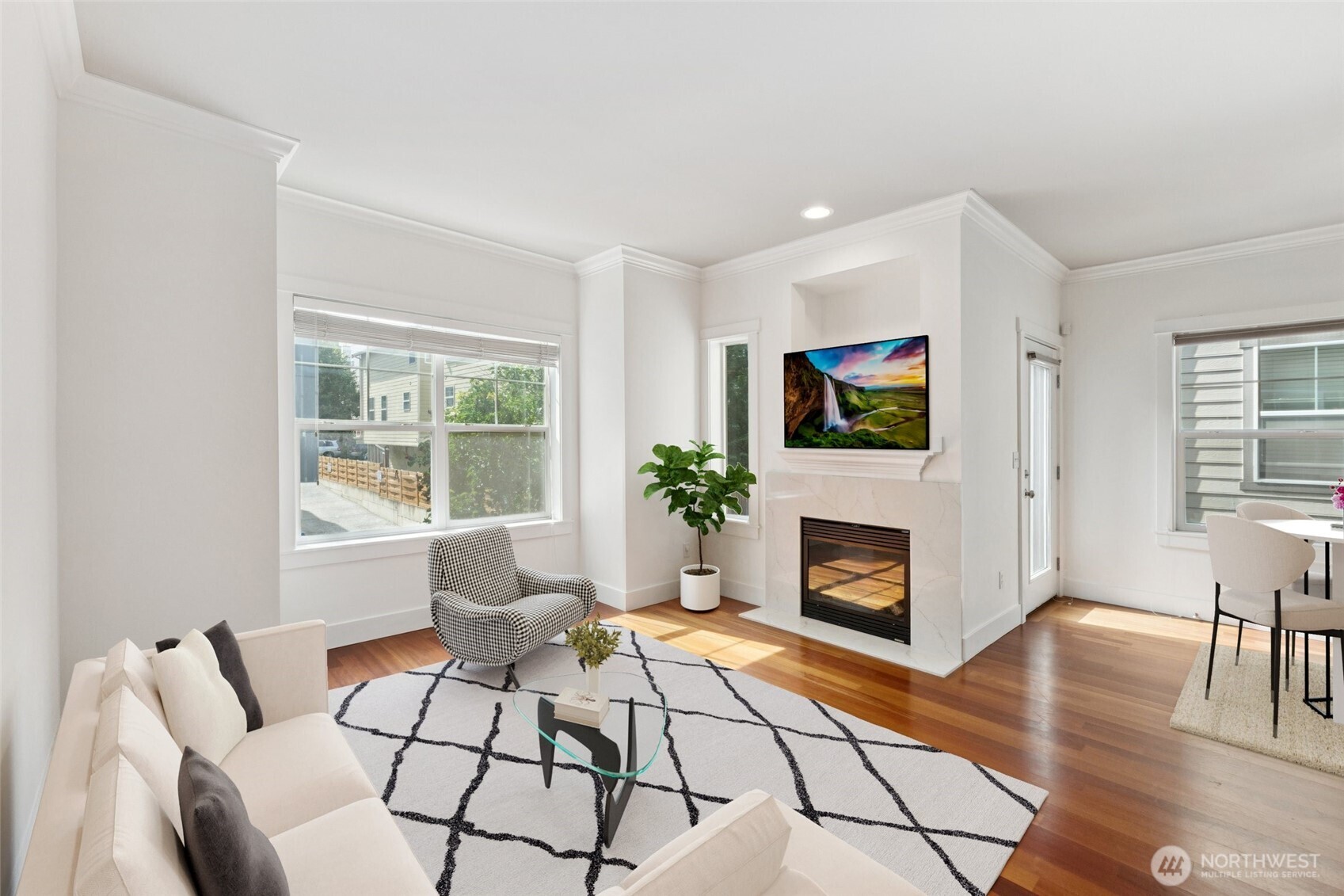 9503 Ashworth Avenue North, Unit B Seattle, WA 98103 - Photo 6 of 26 a living room with furniture a fireplace and a flat screen tv