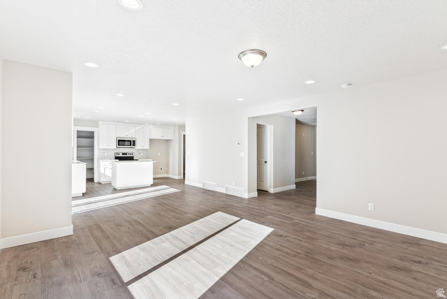 257 North Slant Road, Unit 51M Mapleton, UT 84660 - Photo 10 of 24 Unfurnished living room with dark wood-style floors and recessed lighting