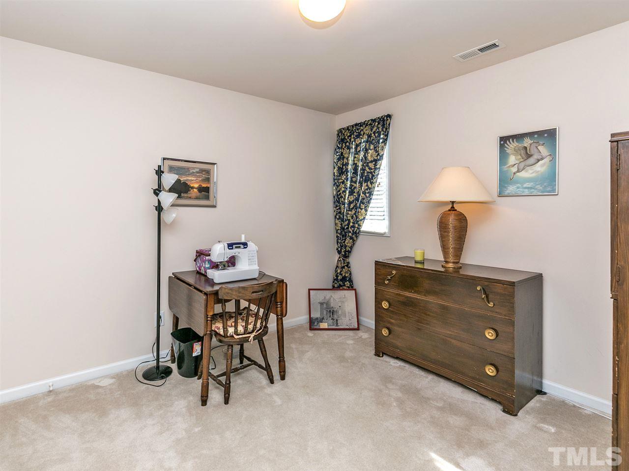 8109 Satillo Lane Raleigh, NC 27616 - Photo 18 of 25 This bedroom has access to a bathroom just outside the door. It can easily handle a double bed - it is currently being used as a sewing room.