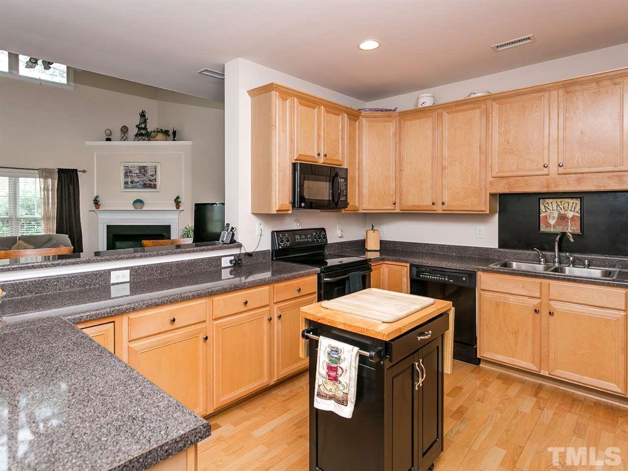 8109 Satillo Lane Raleigh, NC 27616 - Photo 5 of 25 Loads of counter and cabinet space plus a handy snack bar add exceptional functionality to this kitchen.