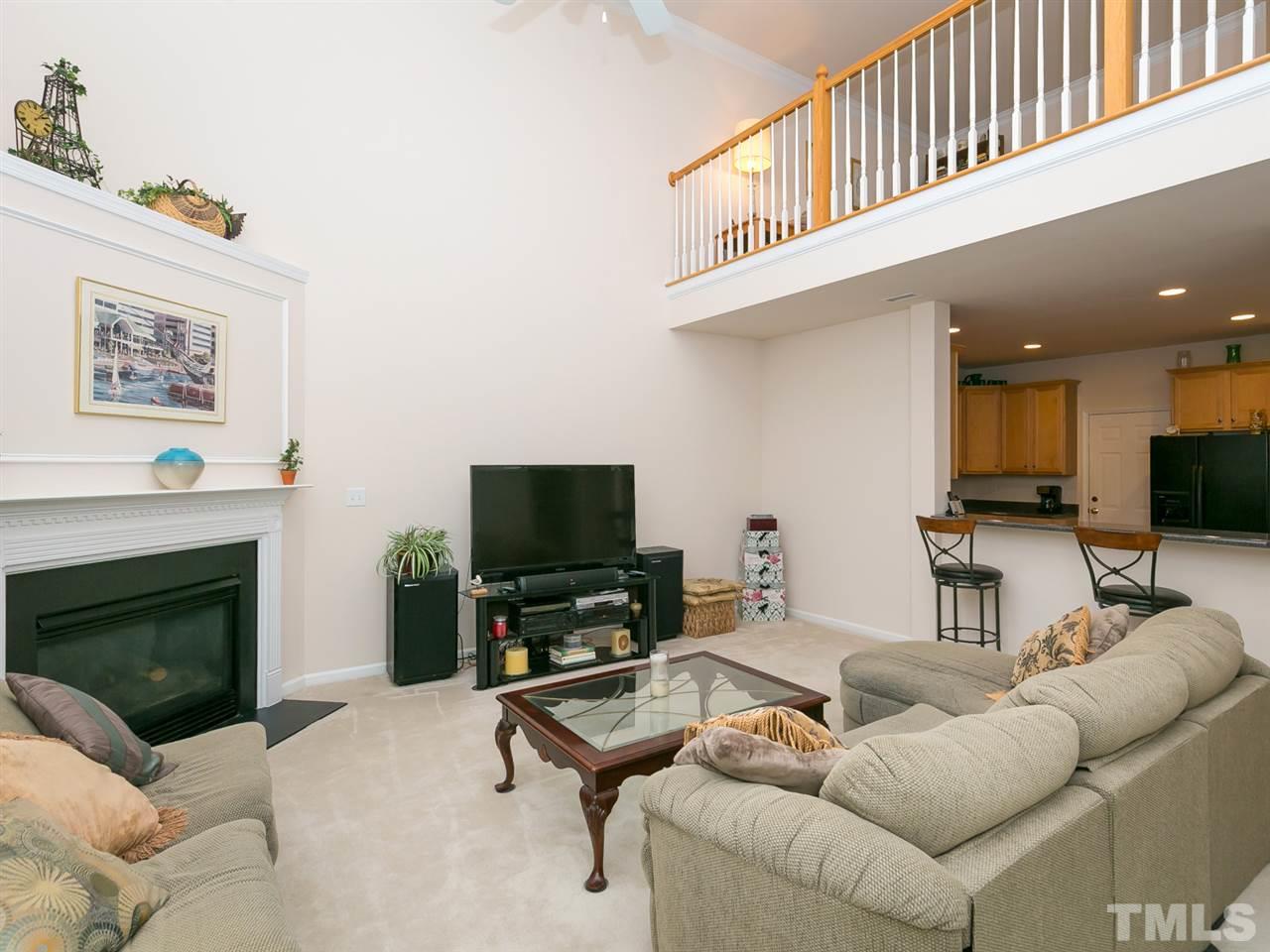 8109 Satillo Lane Raleigh, NC 27616 - Photo 8 of 25 The family room has a corner fireplace for cozy evenings and access to the rear patio for those times when you want to grill out.