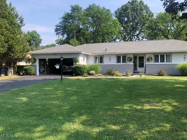1989 Larchmont Road Akron, OH 44313 - Photo 36 of 38 Ranch-style house featuring an attached garage, aphalt driveway, and a front yard