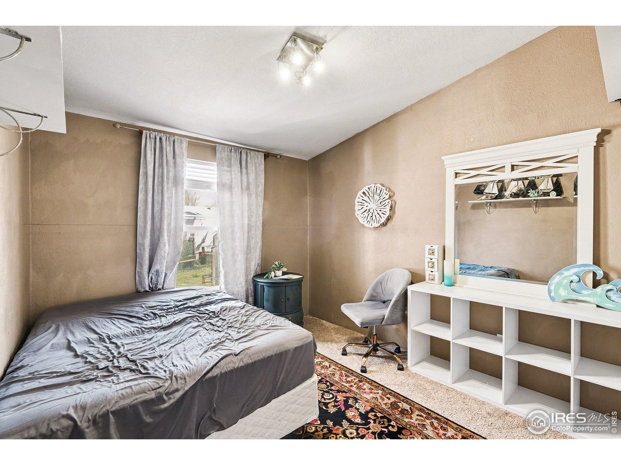 2500 East Harmony Road, Unit 269 Fort Collins, CO 80528 - Photo 11 of 22 a bedroom with a bed and a table with chair