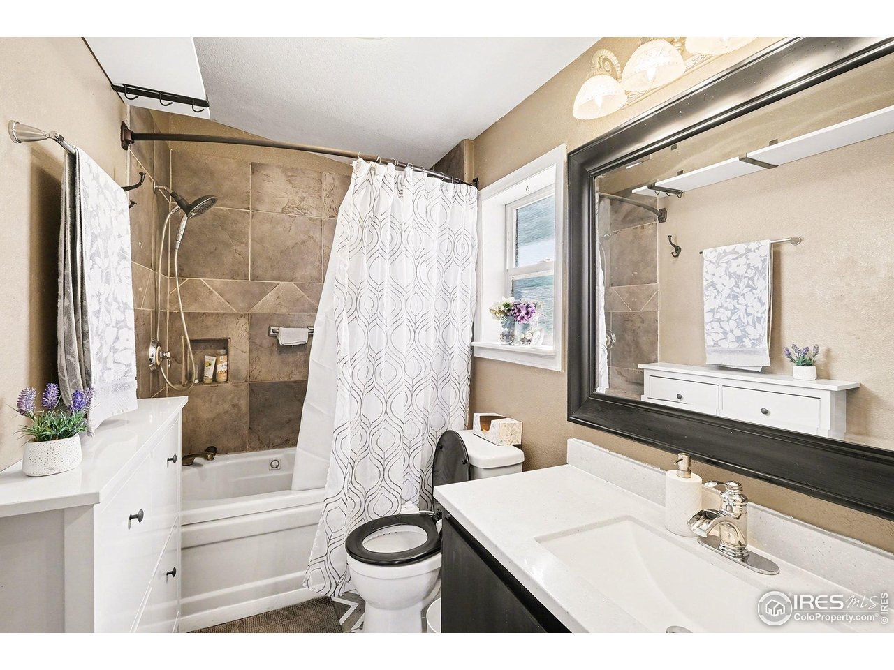 2500 East Harmony Road, Unit 269 Fort Collins, CO 80528 - Photo 16 of 22 a bathroom with a sink a toilet a mirror a bathtub and shower