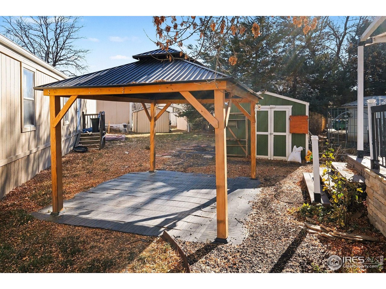 2500 East Harmony Road, Unit 269 Fort Collins, CO 80528 - Photo 2 of 22 a backyard of a house with barbeque oven table and chairs