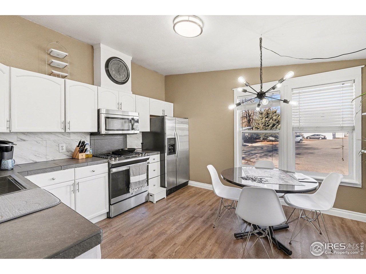 2500 East Harmony Road, Unit 269 Fort Collins, CO 80528 - Photo 3 of 22 a kitchen with stainless steel appliances kitchen island granite countertop a table chairs and a stove