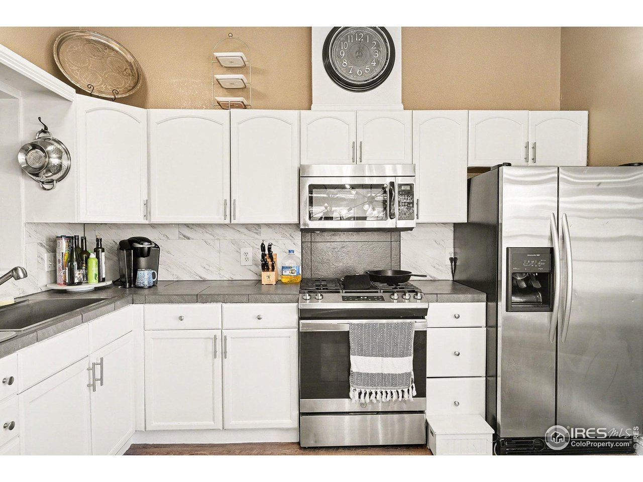 2500 East Harmony Road, Unit 269 Fort Collins, CO 80528 - Photo 8 of 22 a kitchen with a stove a refrigerator and cabinets