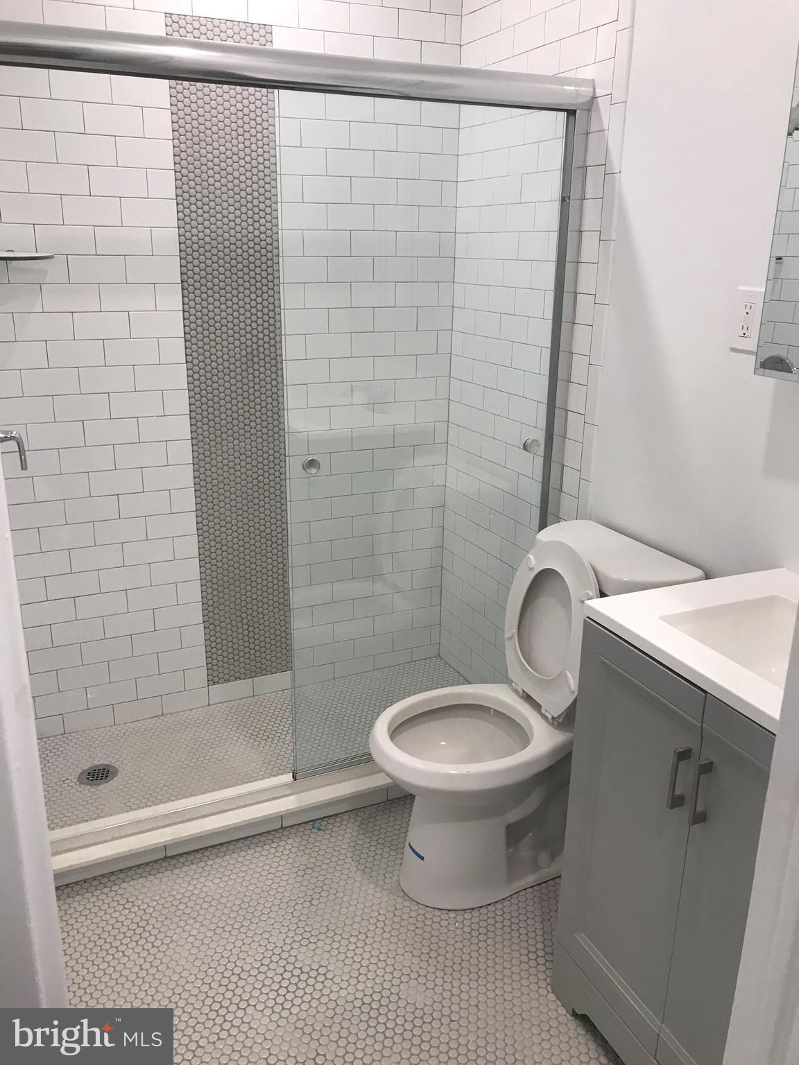 135 South 19th Street, Unit 1007 Philadelphia, PA 19103 - Photo 6 of 13 a bathroom with a shower and a toilet