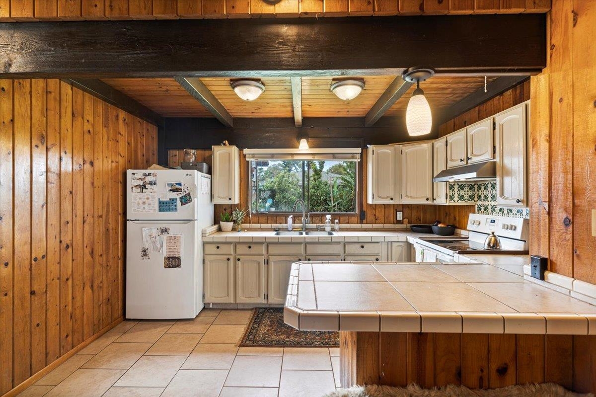 11 Keola Place Makawao, HI 96768 - Photo 11 of 45 a kitchen with a stove a refrigerator and cabinets