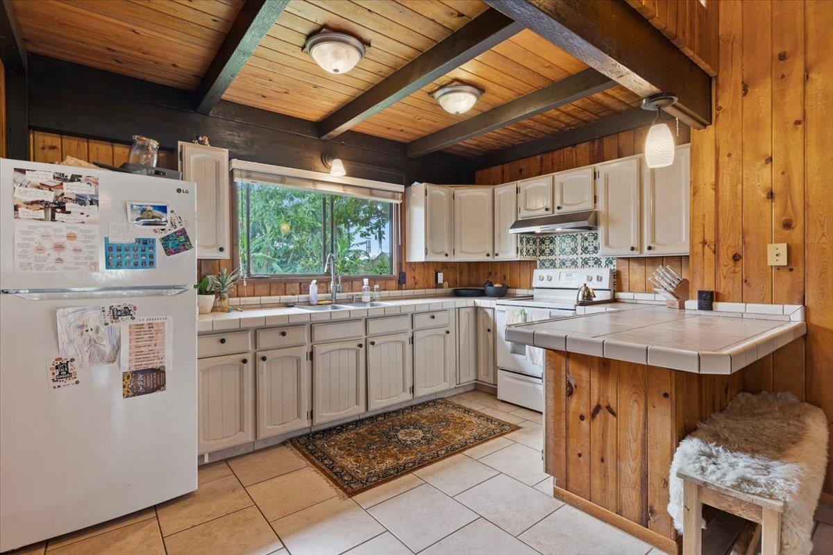 11 Keola Place Makawao, HI 96768 - Photo 12 of 45 a kitchen with a sink window and cabinets
