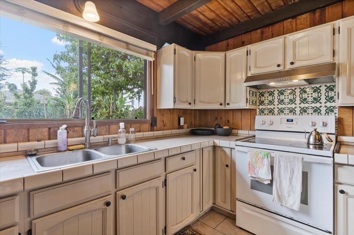 11 Keola Place Makawao, HI 96768 - Photo 13 of 45 a kitchen with a sink window and cabinets