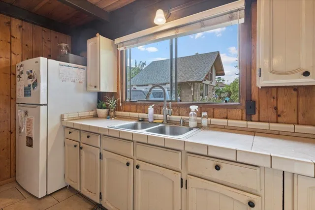 a kitchen with appliances a sink and cabinets