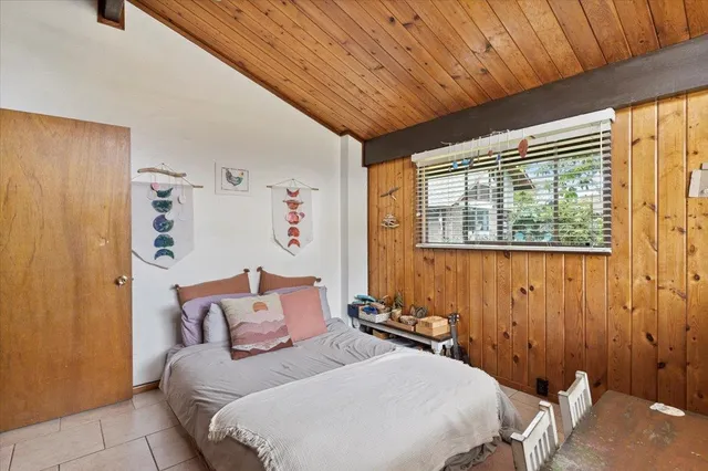 a bedroom with a bed and a table