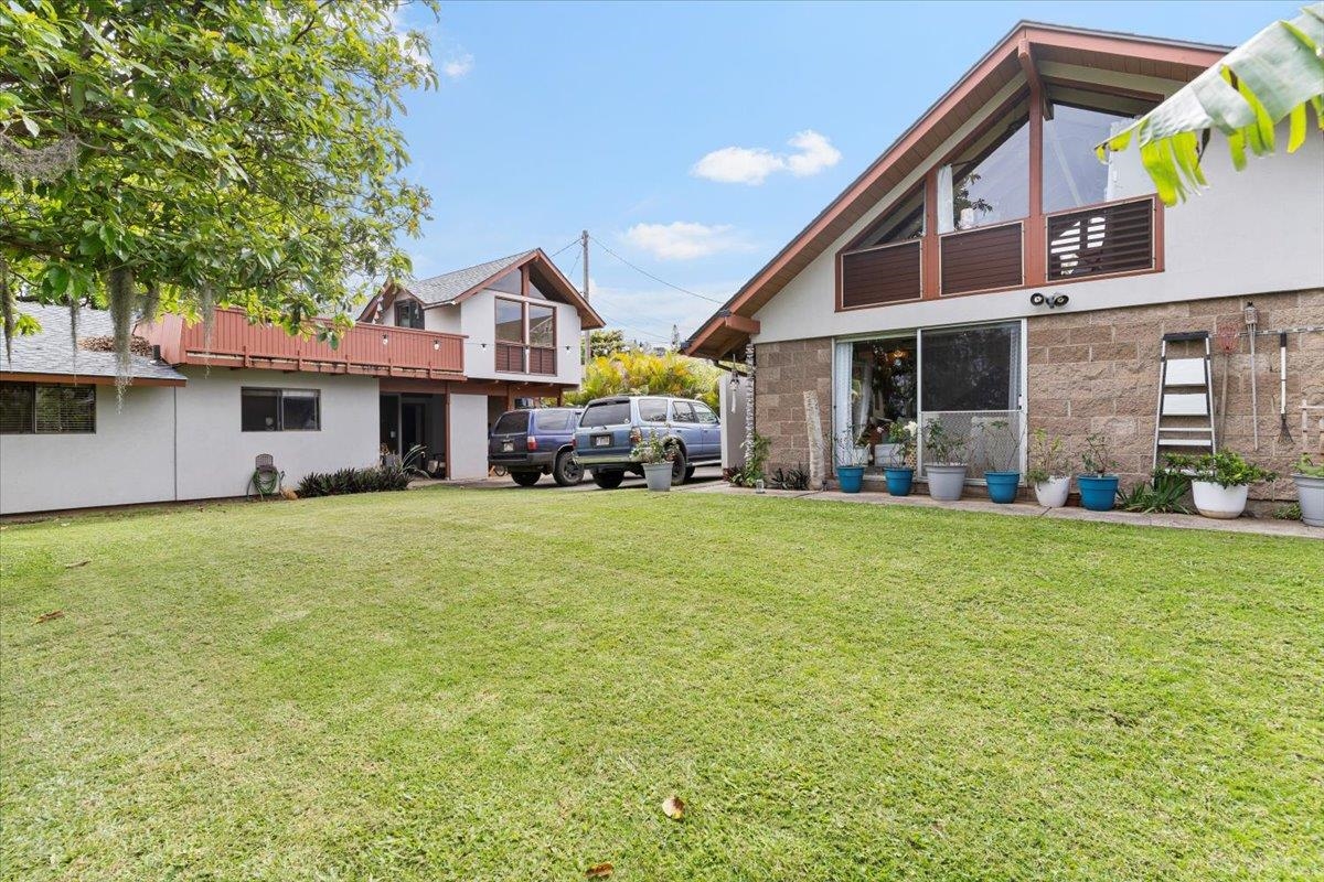 11 Keola Place Makawao, HI 96768 - Photo 29 of 45 a front view of a house with a garden and trees