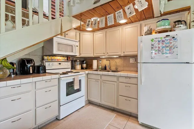 a kitchen with stove and cabinets