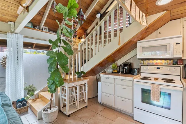 a bedroom with a bed and a large window with balcony view