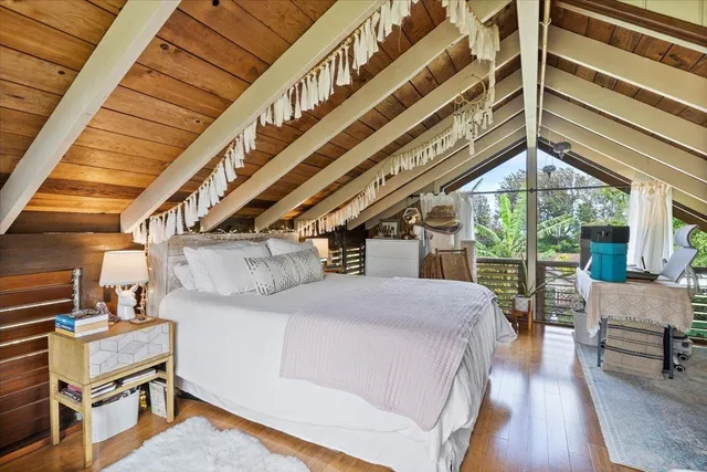 a bedroom with a bed next to a window