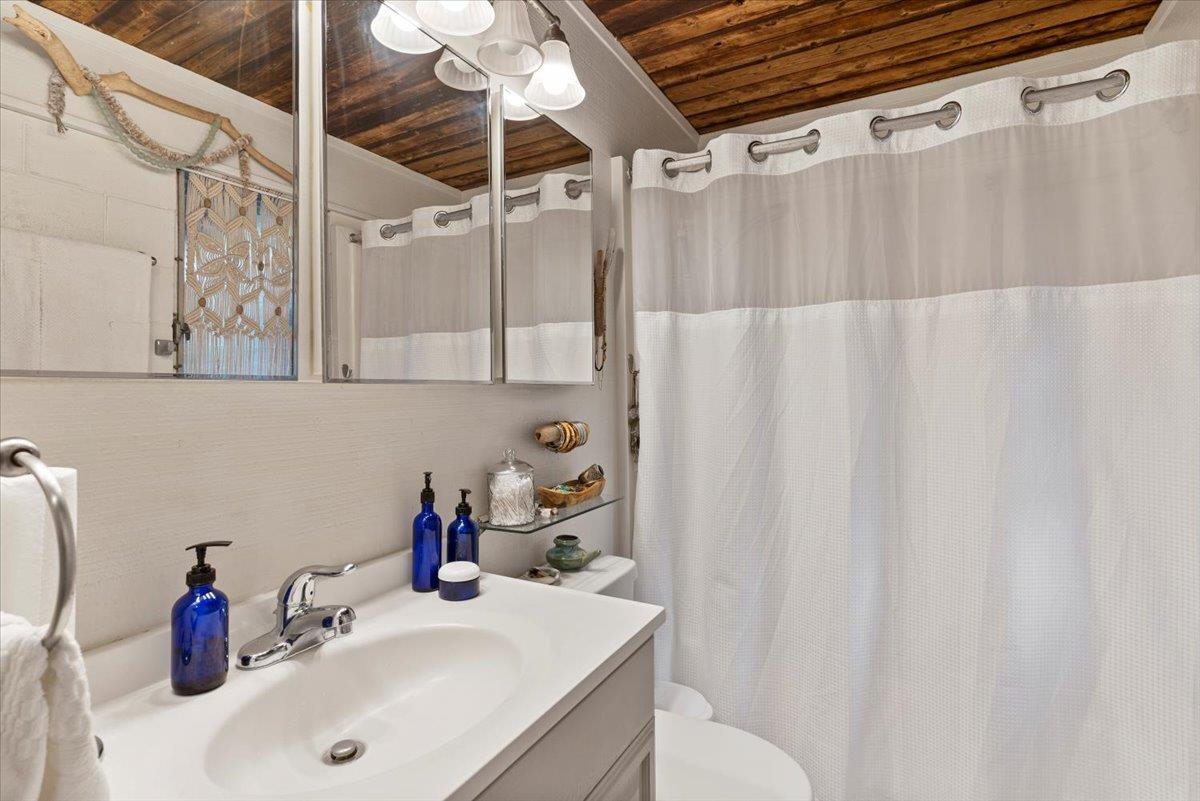 11 Keola Place Makawao, HI 96768 - Photo 41 of 45 a bathroom with a sink and a shower curtain