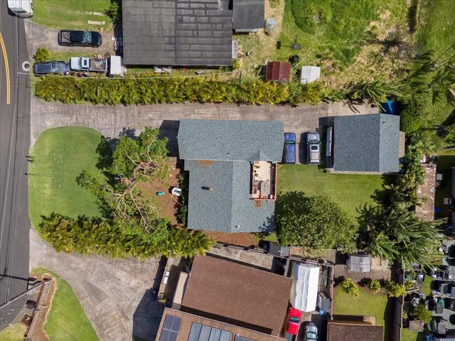 an aerial view of a house with a yard basket ball court and outdoor seating
