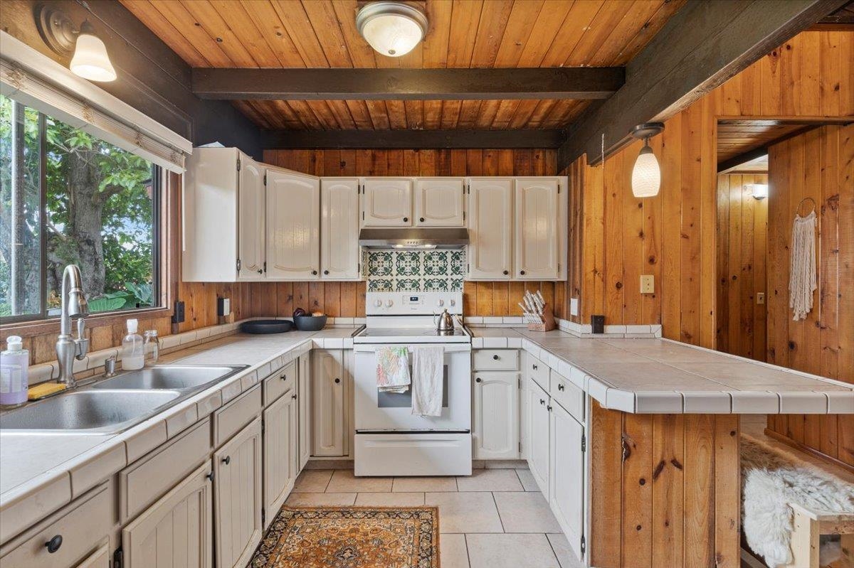 11 Keola Place Makawao, HI 96768 - Photo 10 of 45 a kitchen with a sink stove and cabinets