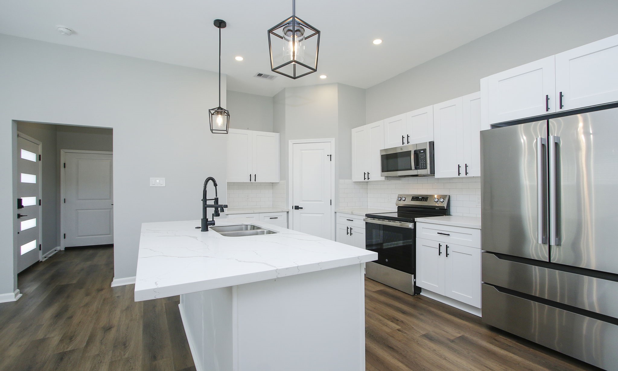 4337 Faulkner Street Houston, TX 77021 - Photo 9 of 39 a kitchen with a sink stainless steel appliances and wooden floor