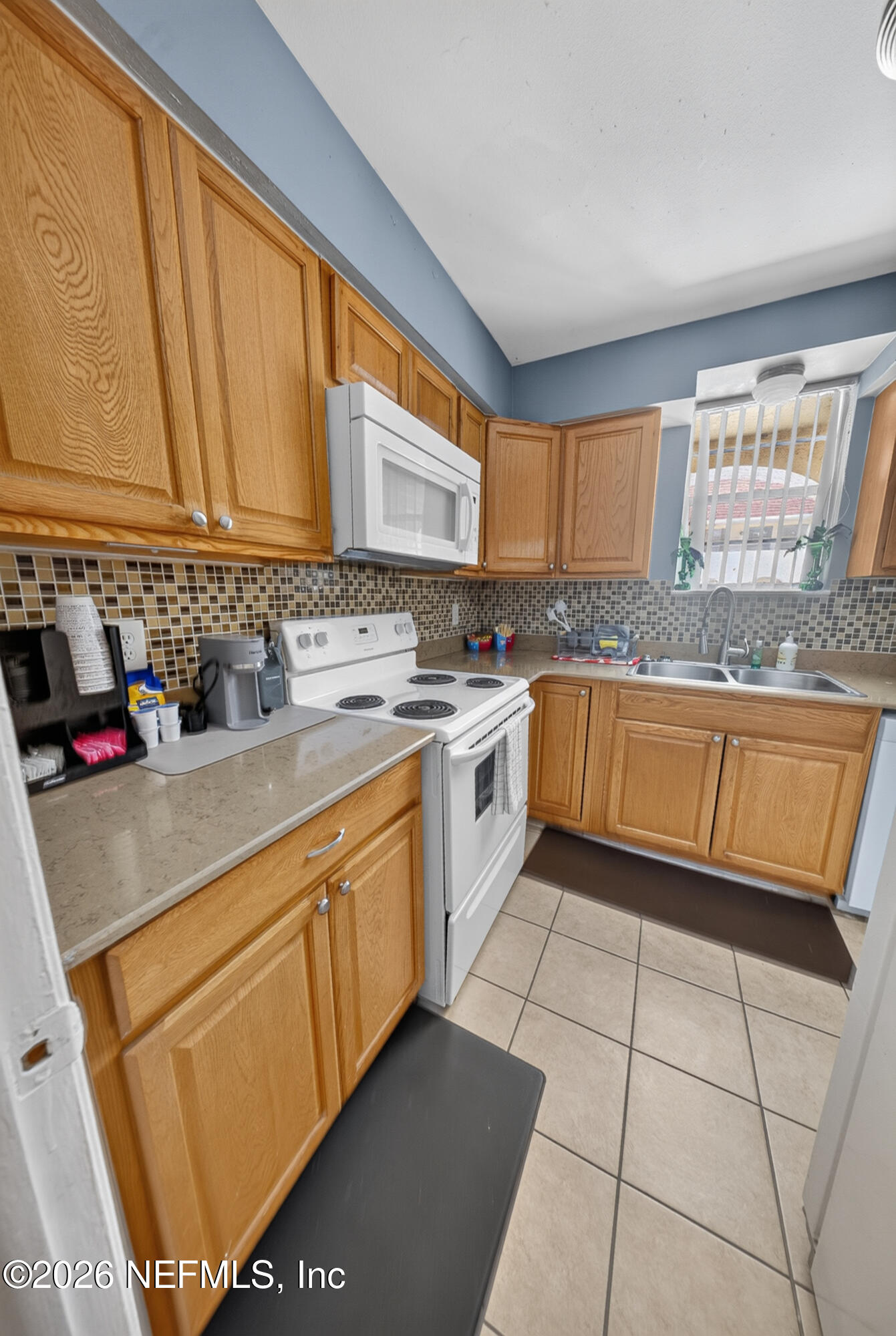 7346 El Barco Road, Unit 4 Jacksonville, FL 32216 - Photo 5 of 19 a kitchen with stainless steel appliances granite countertop a sink stove and cabinets