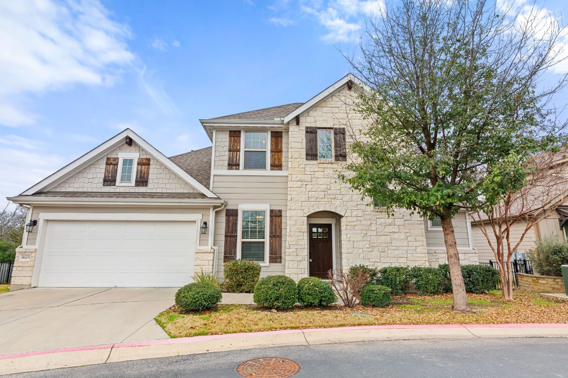 a view of a white house with large windows and a large tree