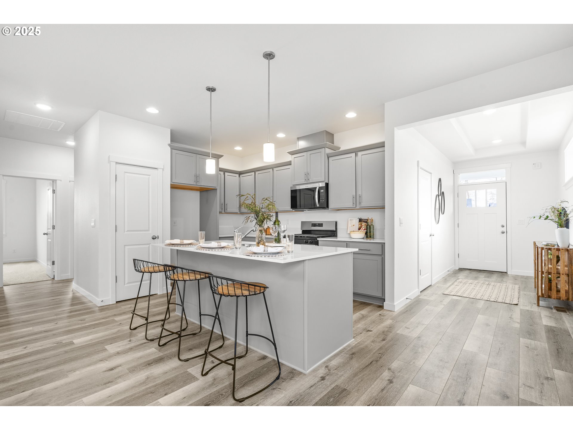665 Parker Loop Silverton, OR 97381 - Photo 12 of 38 a kitchen with stainless steel appliances kitchen island a sink cabinets and wooden floor