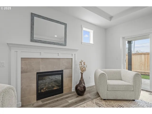 a living room with furniture a window and a fireplace
