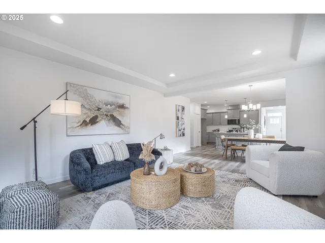 a living room with furniture and view of kitchen