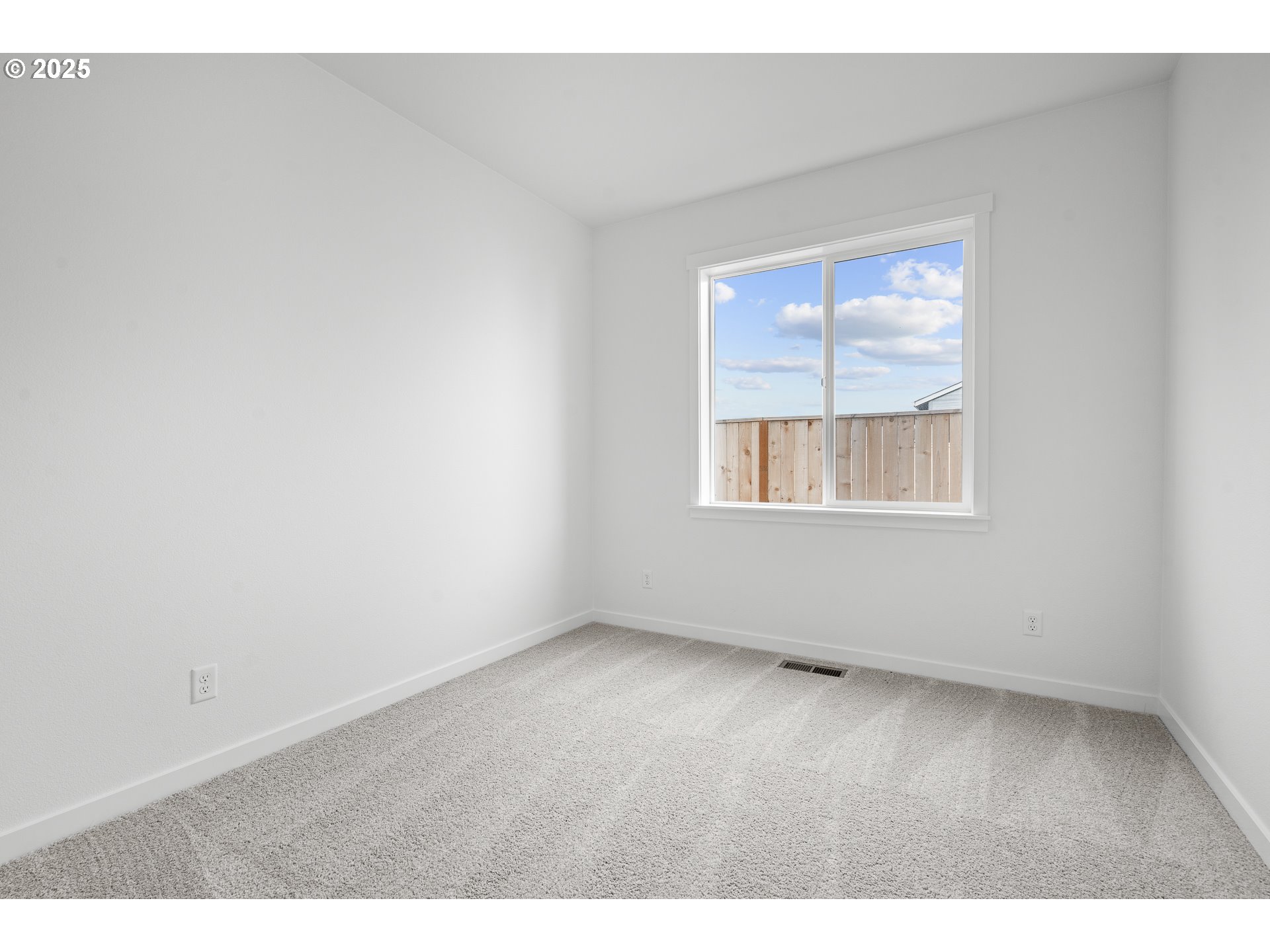 665 Parker Loop Silverton, OR 97381 - Photo 24 of 38 an empty room with wooden floor and windows