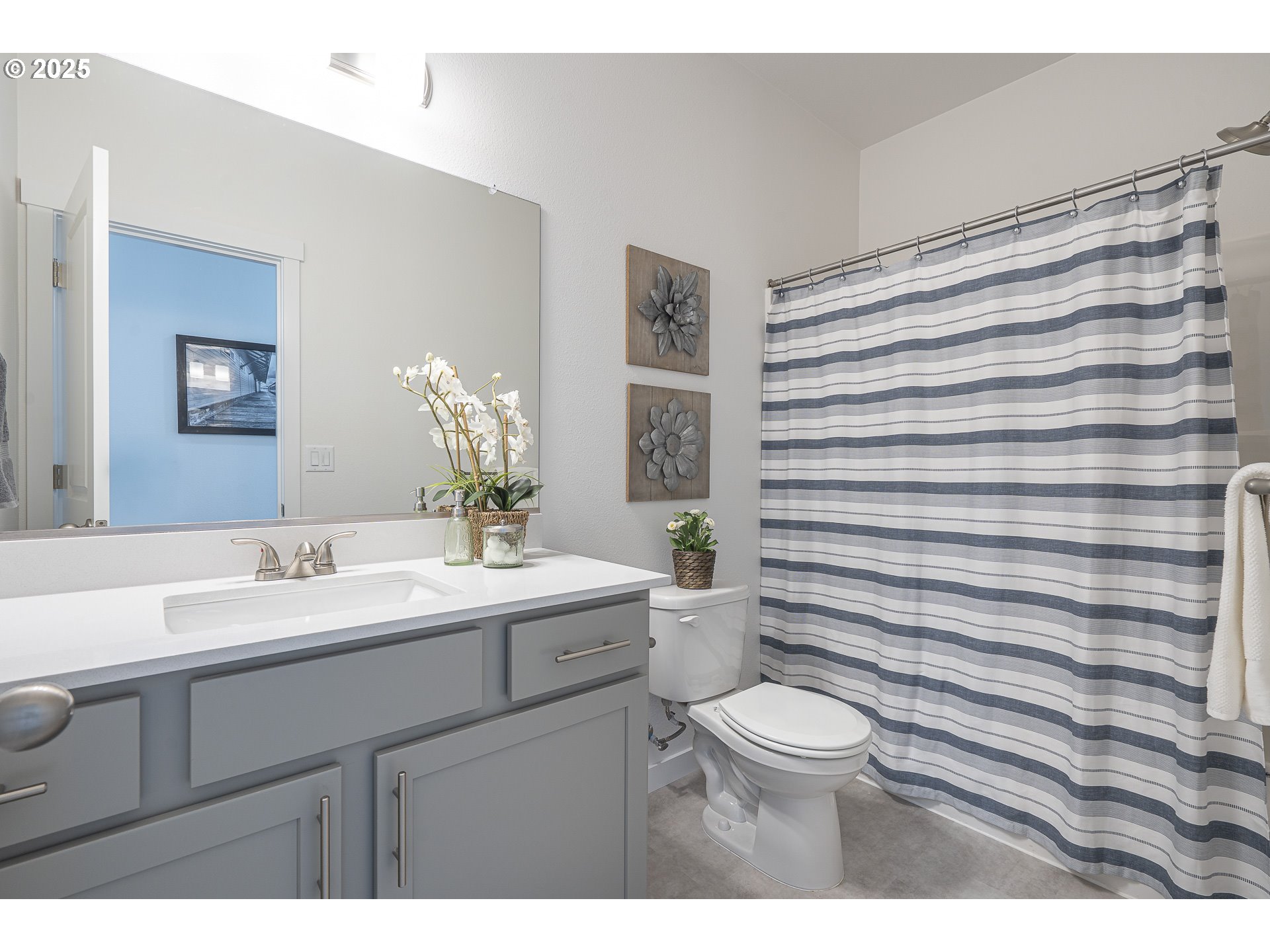 665 Parker Loop Silverton, OR 97381 - Photo 26 of 38 a bathroom with a sink a toilet a mirror and shower curtain