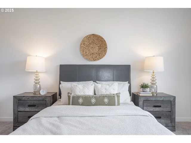 a bedroom with a bed and a lamp