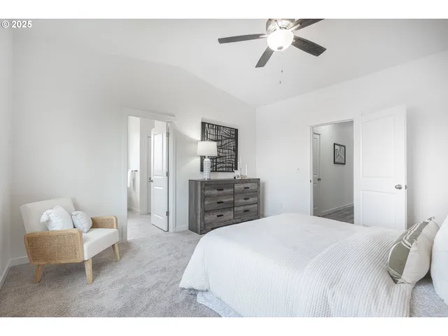 a spacious bedroom with a bed and a chandelier