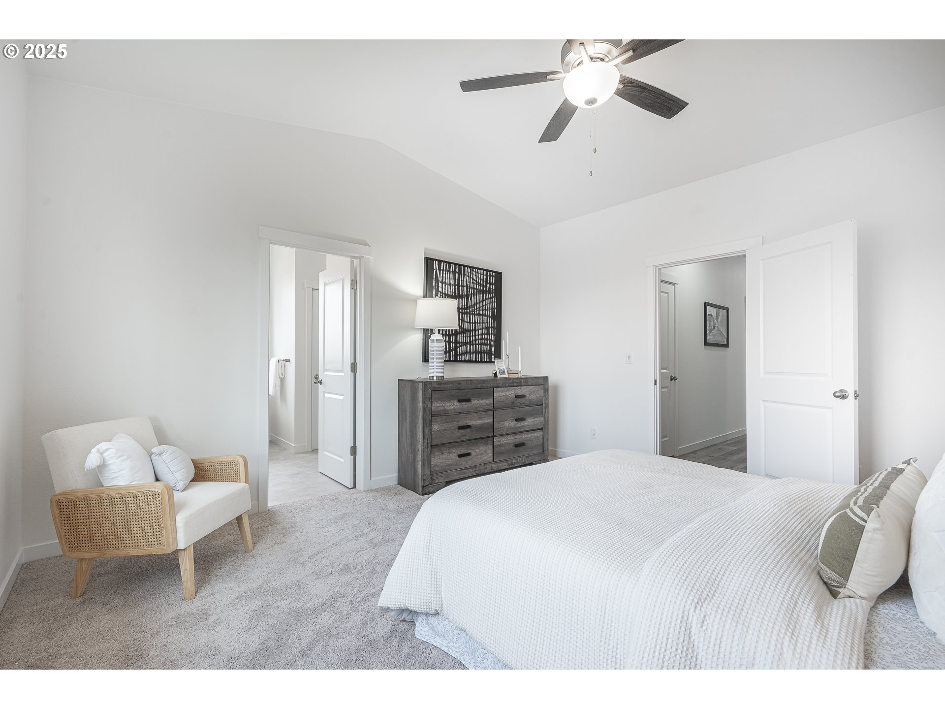 665 Parker Loop Silverton, OR 97381 - Photo 30 of 38 a spacious bedroom with a bed and a chandelier