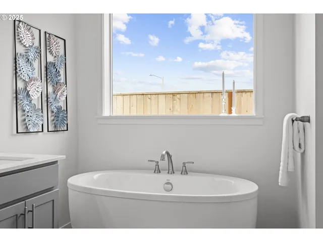 a bathroom with a sink mirror and a window