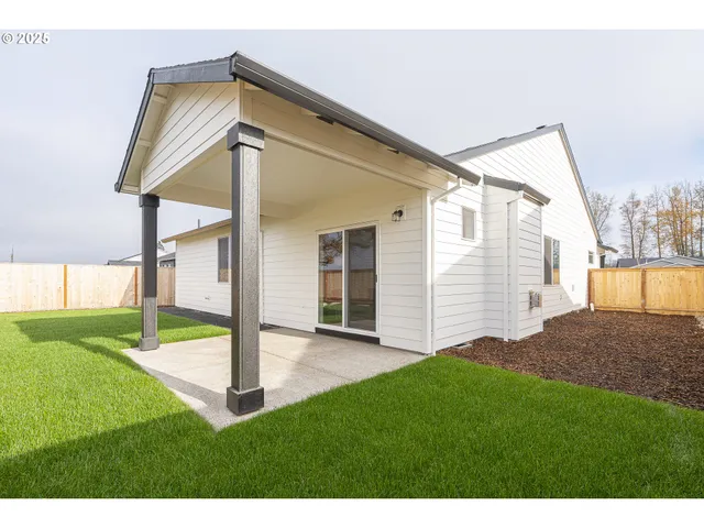 a view of an house with backyard and porch