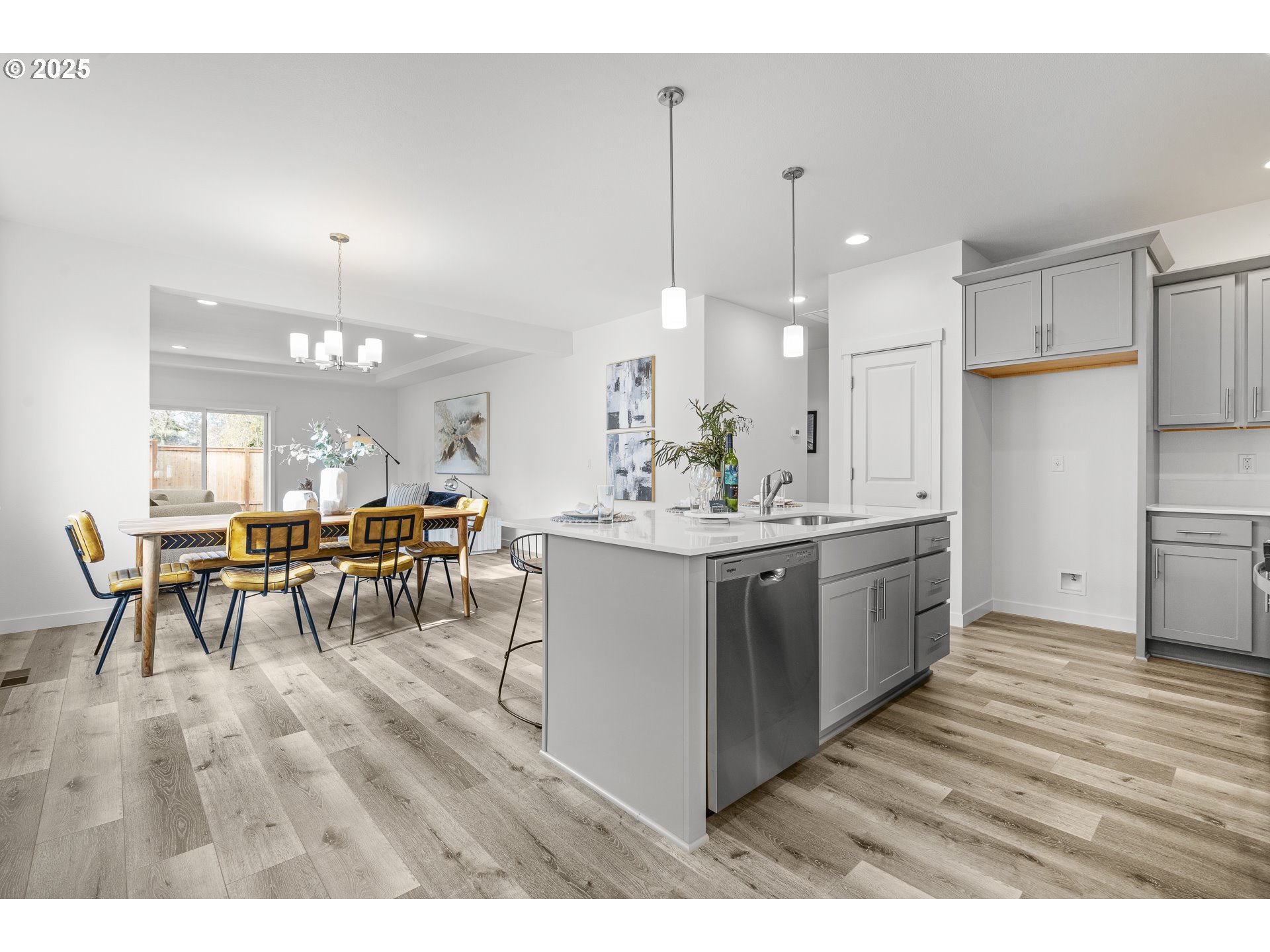 665 Parker Loop Silverton, OR 97381 - Photo 7 of 38 a kitchen with stainless steel appliances kitchen island granite countertop a table chairs and a refrigerator