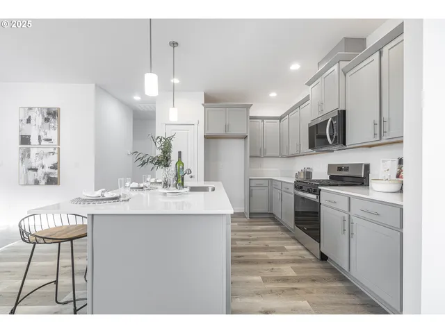 a kitchen with kitchen island granite countertop a sink and cabinets