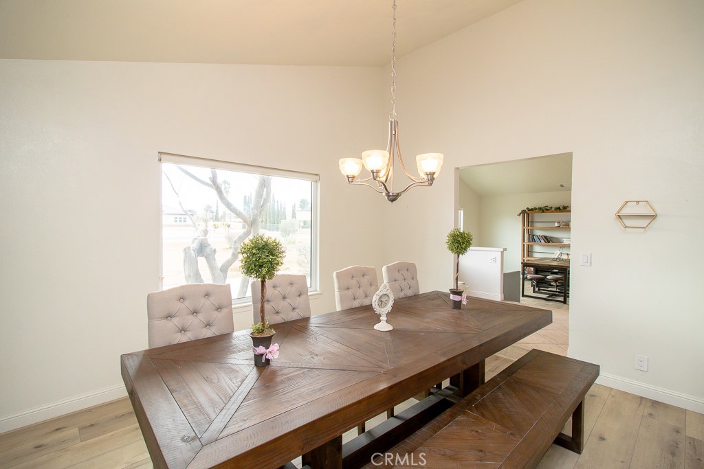 20376 Tonawanda Road Apple Valley, CA 92307 - Photo 13 of 67 a view of a dining room with furniture a chandelier and wooden floor