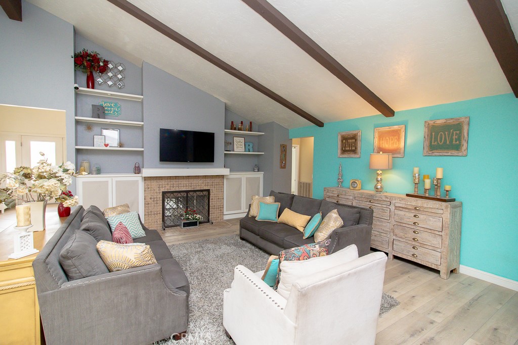 20376 Tonawanda Road Apple Valley, CA 92307 - Photo 17 of 67 a living room with furniture a fireplace and a flat screen tv