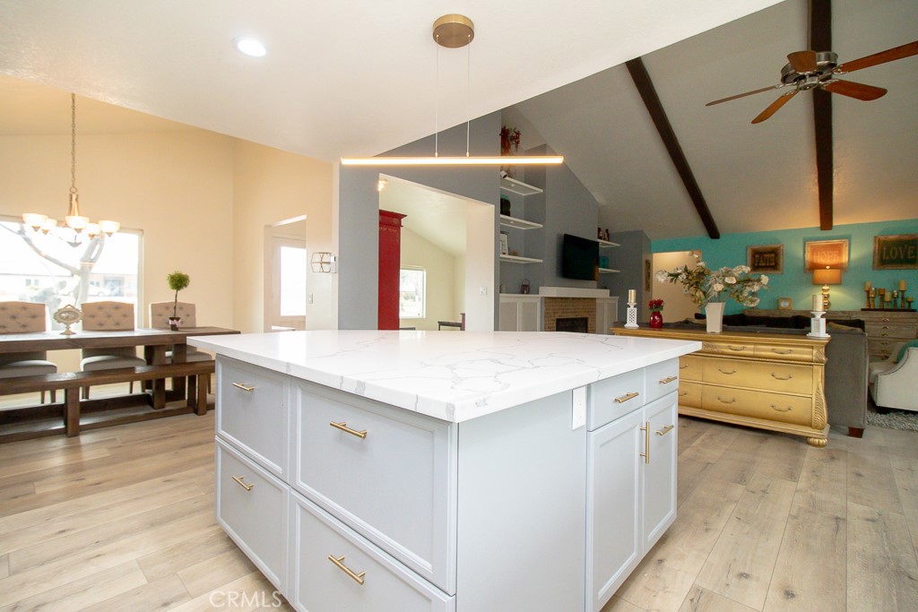 20376 Tonawanda Road Apple Valley, CA 92307 - Photo 20 of 67 a kitchen with a sink dishwasher a stove and a dining table with wooden floor