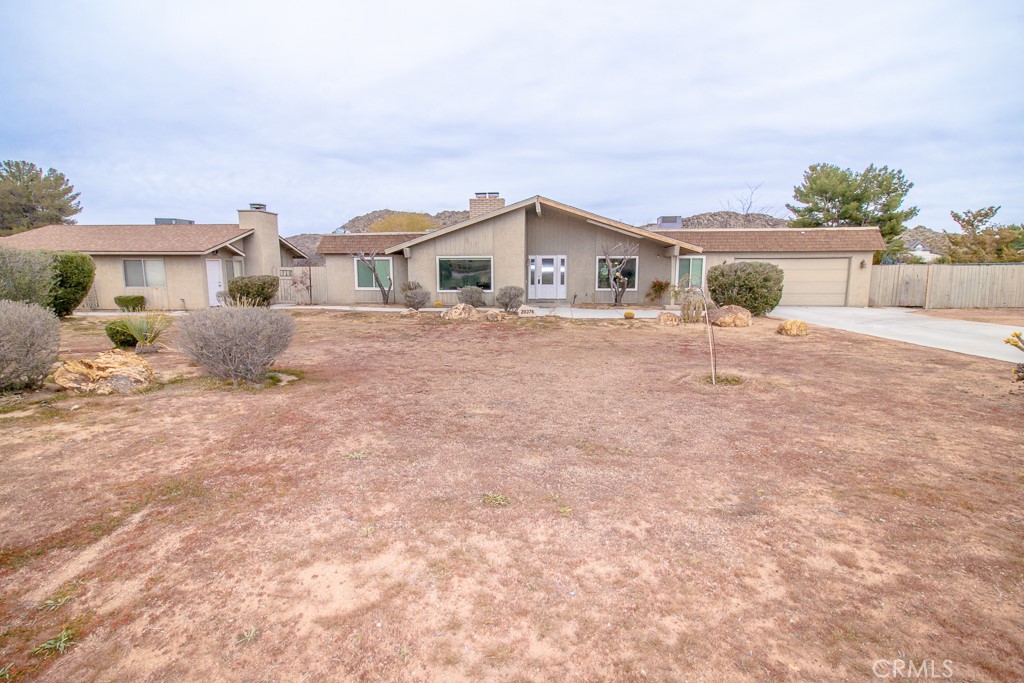 20376 Tonawanda Road Apple Valley, CA 92307 - Photo 2 of 67 a front view of a house with a yard and garage