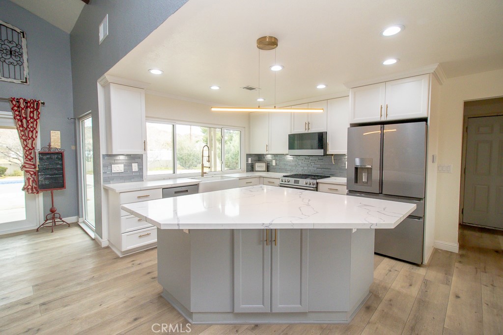 20376 Tonawanda Road Apple Valley, CA 92307 - Photo 24 of 67 a large kitchen with stainless steel appliances kitchen island granite countertop a refrigerator a stove a sink and a oven